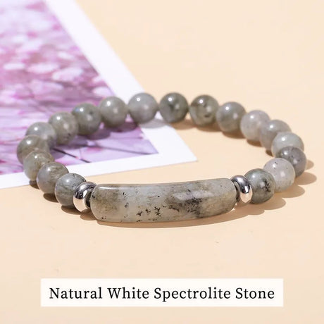 Necklace with natural white spectrolite stone on a beige background