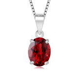 Red gemstone pendant on a silver chain against a white background
