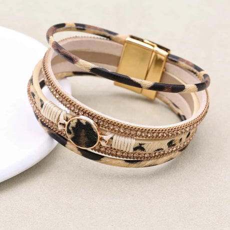 Multistrand bracelet with leopard print and gold accents on a light background