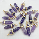 Purple crystal pendants with gold accents on a white background