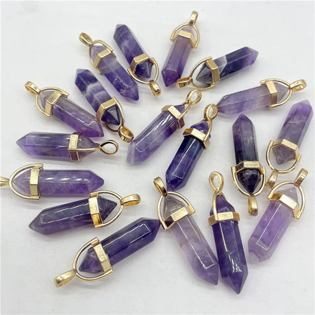 Purple crystal pendants with gold accents on a white background