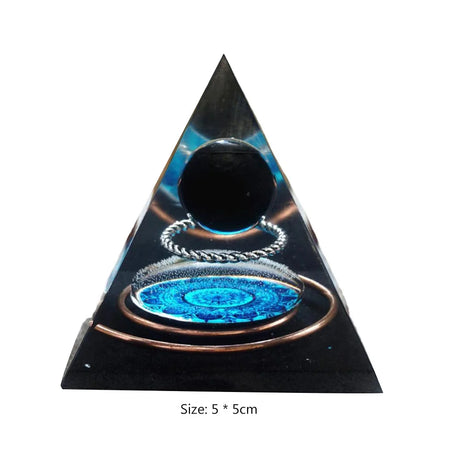 Pyramid-shaped object with glowing blue and black design on a white background