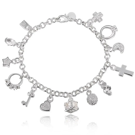 Silver charm bracelet with various charms on a white background
