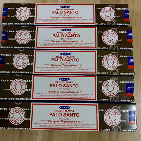 Multiple boxes of Nag Champa Palo Santo incense on a wooden surface