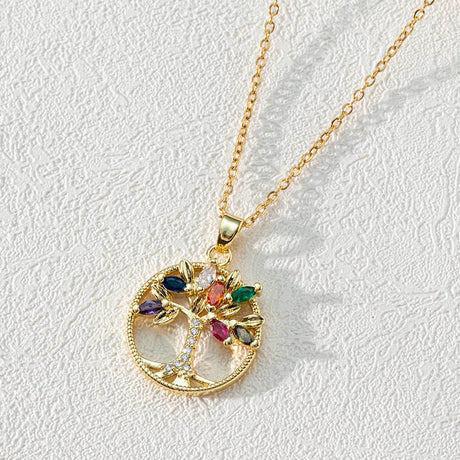 Gold necklace with a colorful pendant on a light gray background