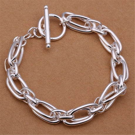 Silver chain bracelet on a brown background