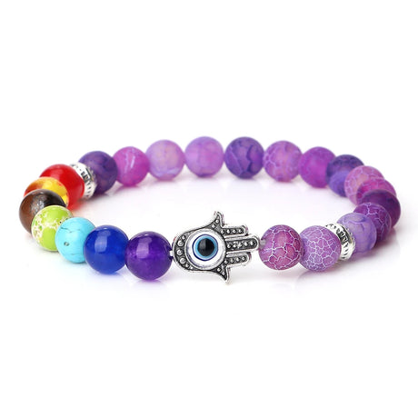 Multicolored beaded bracelet with a silver eye charm on a white background