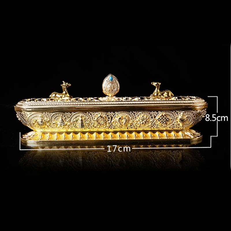 Decorative gold box with intricate designs on a black background