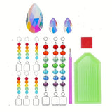 Set of crystal beads, tools, and molds on a white background