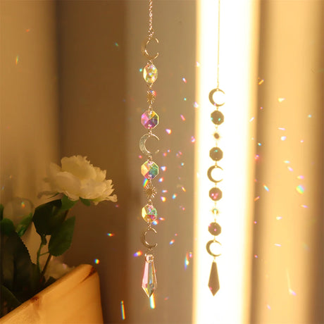 Decorative hanging crystal with rainbow折射效果, placed against a neutral background.