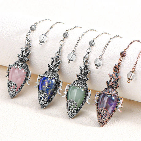 Five decorative pendants with colorful gemstones on a white surface