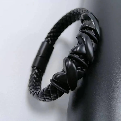 Black braided bracelet on a neutral background