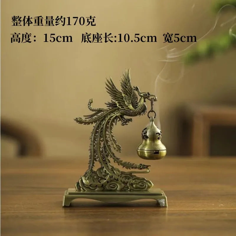 Bronze dragon figurine with a bell on a wooden surface