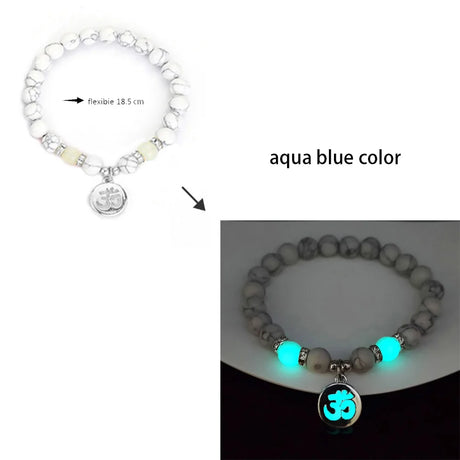 Bracelet with glowing beads and Om charm on a white background