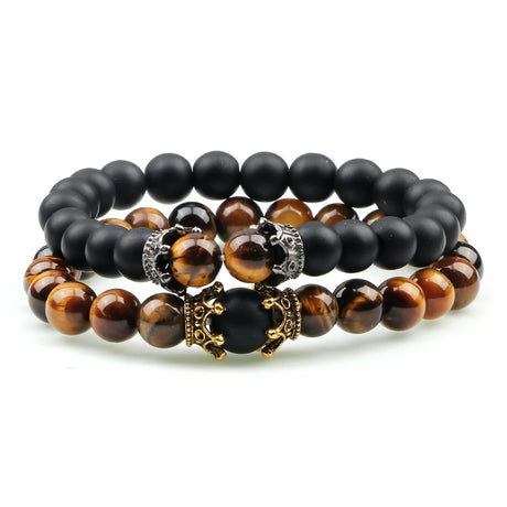 Set of black and brown beaded bracelets with decorative clasps on a white background