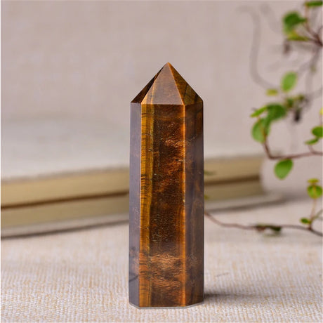 Tiger's eye crystal tower on a neutral background
