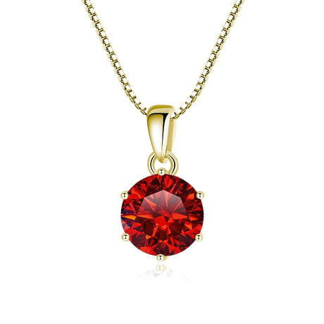 Gold necklace with a red gemstone pendant on a white background