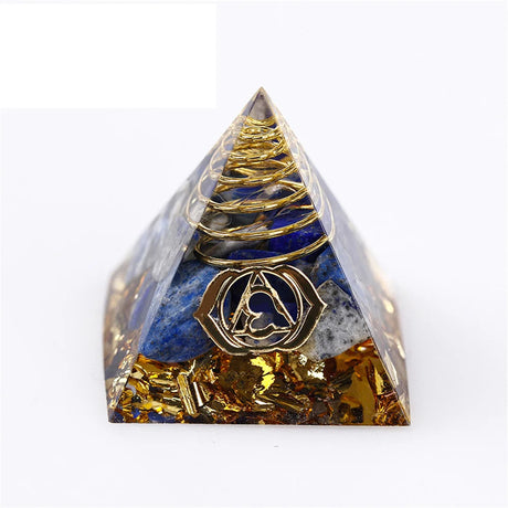 Pyramid-shaped crystal with gold and blue elements on a white background