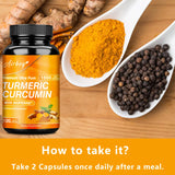 Turmeric Curcumin supplement bottle with turmeric powder and black pepper on a wooden surface