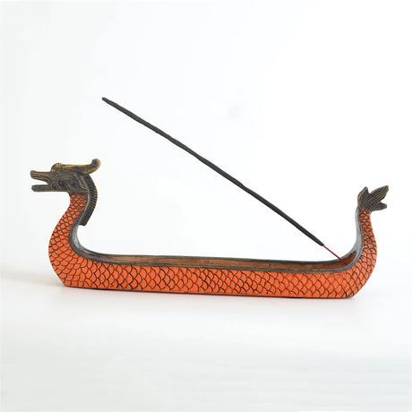 Dragon boat incense burner with a single incense stick on a white background