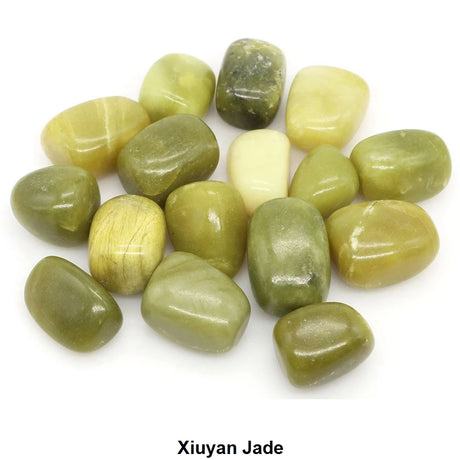 Collection of green jade stones on a white background