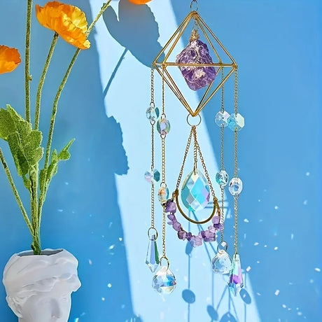 Decorative hanging with crystals and gemstones next to a vase with flowers on a blue background