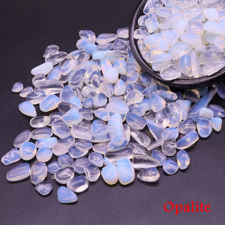 Opalite stones with a bowl of stones on a black background.