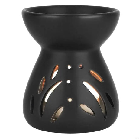 Black ceramic oil burner with decorative cutouts on a white background