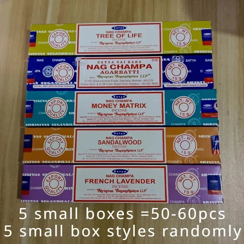 Collection of Nag Champa incense boxes on a wooden surface with text indicating quantity and box styles.