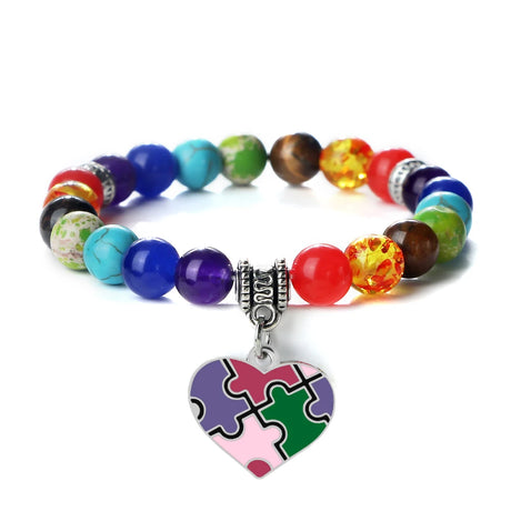 Colorful beaded bracelet with a heart-shaped puzzle piece charm on a white background