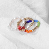 Set of colorful beaded bracelets on a white fabric background