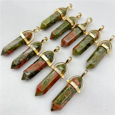 Set of green and red stone pendants with gold accents on a white background