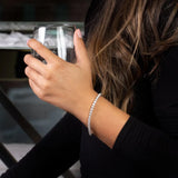 Person holding a glass of red wine with a blurred background
