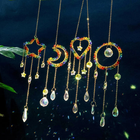 Colorful hanging decorative items with star, moon, and heart shapes against a dark background.