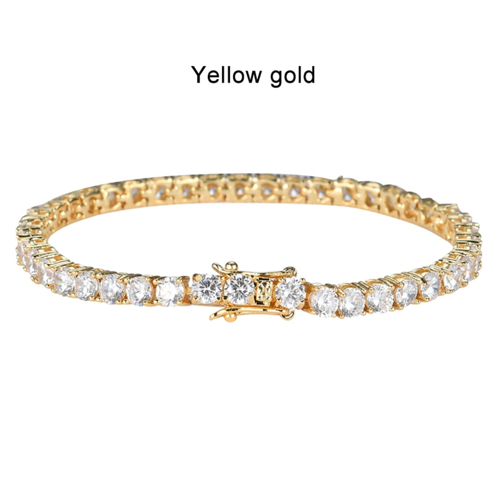 Gold bracelet with clear stones on a white background