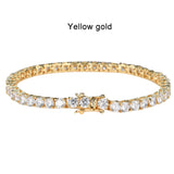 Gold bracelet with clear stones on a white background