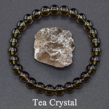 Tea crystal bracelet with a rough crystal on a gray background