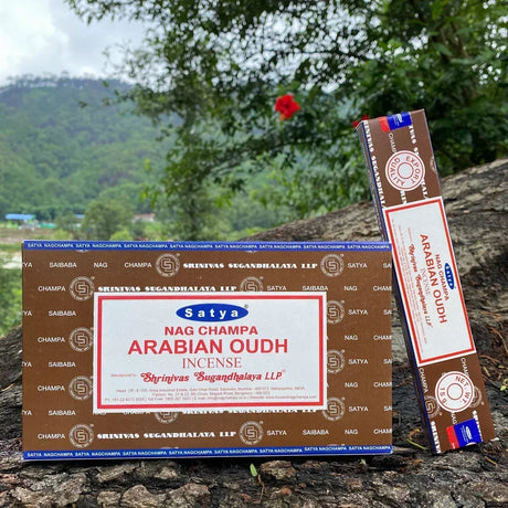 Satya Nag Champa Arabian Oudh incense packaging on a natural background