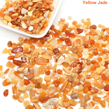 Yellow jade stones with a white bowl on a white background