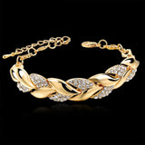 Gold bracelet with crystal accents on a black background