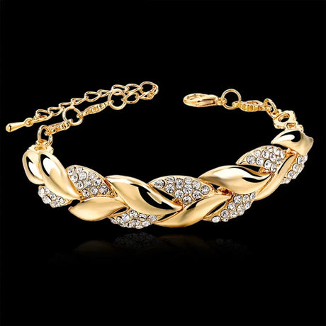 Gold bracelet with crystal accents on a black background