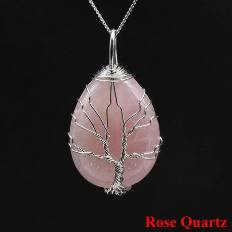 Rose Quartz pendant with silver tree design on a black background