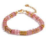 Bracelet with pink beads and gold accents on a white background