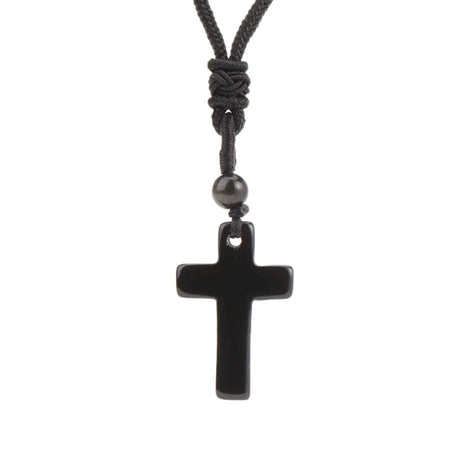 Black cross pendant necklace on a white background