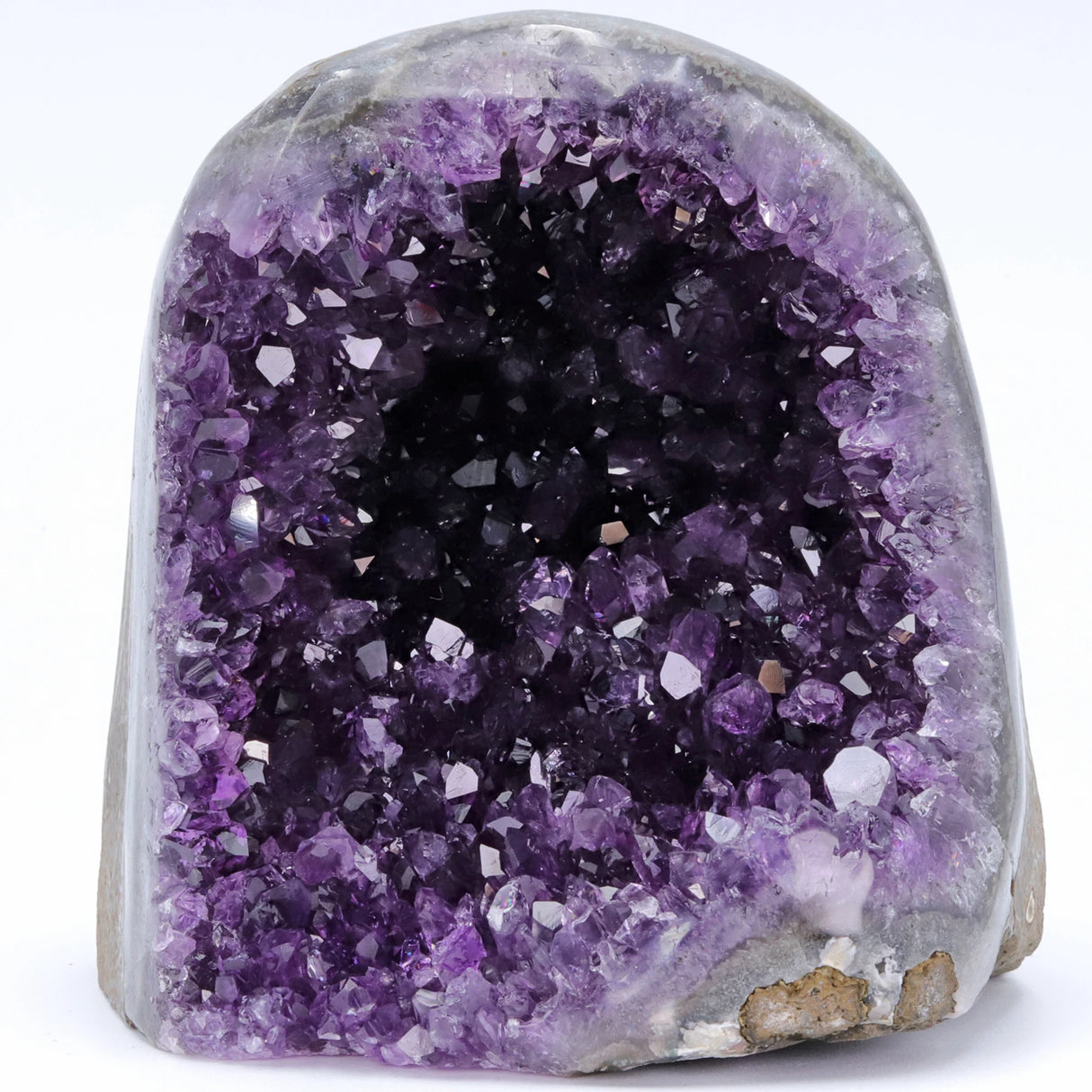 Amethyst geode with purple crystals on a white background