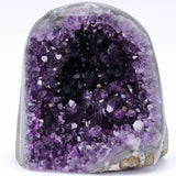 Amethyst geode with purple crystals on a white background