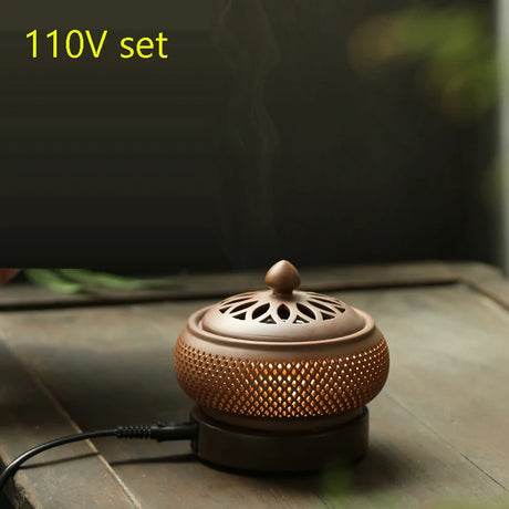 Ceramic incense burner with a smoking top on a wooden surface, labeled '110V set'.