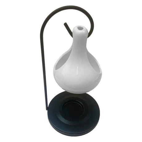 White ceramic oil lamp with black base on a white background