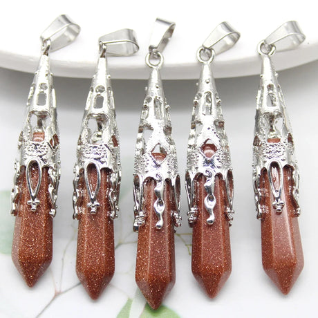 Five goldstone pendants with silver tops on a white background
