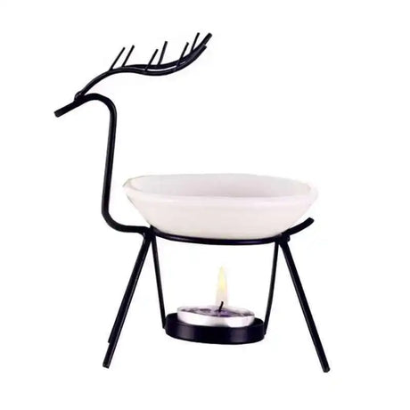 Decorative candle holder with black metal design and white bowl on a white background